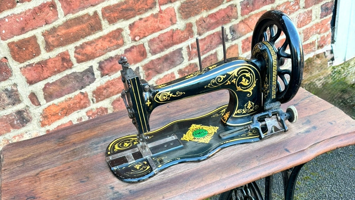 Vintage sewing machine on a wooden table with a brick wall background